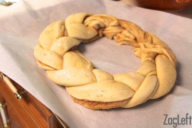 The braided dough shaped into a circle and placed on parchment paper
