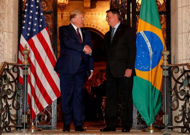 U.S. President Trump shakes hands with Brazil's President Bolsonaro at Mar-a-Lago residency in Palm Beach