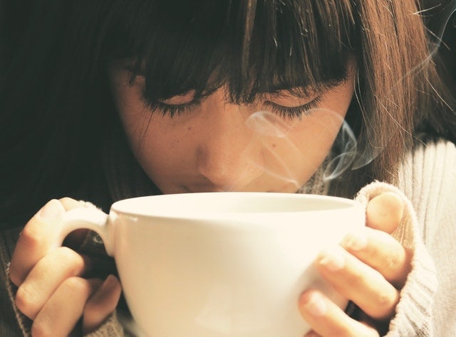girl holding a cup of tea girl holding a cup of tea