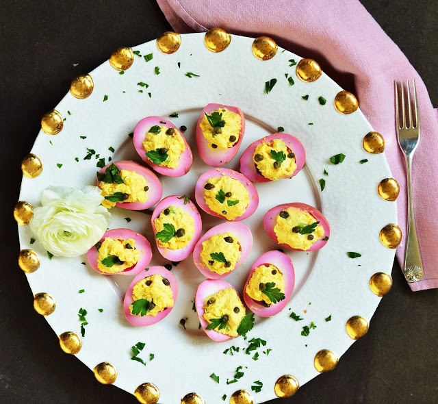 These beet pickled deviled eggs are a perfect use for hard boiled eggs. We also served these at our Passover Seder. So Pretty and easy to make! #eggs #deviledeggs #appetizer www.thisishowicook.com