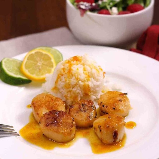 Scallops Recipe with Orange Sauce - sweet citrus sauce served over scallops is a lovely meal that cooks quickly, looks elegant and tastes divine. | One Dish Kitchen