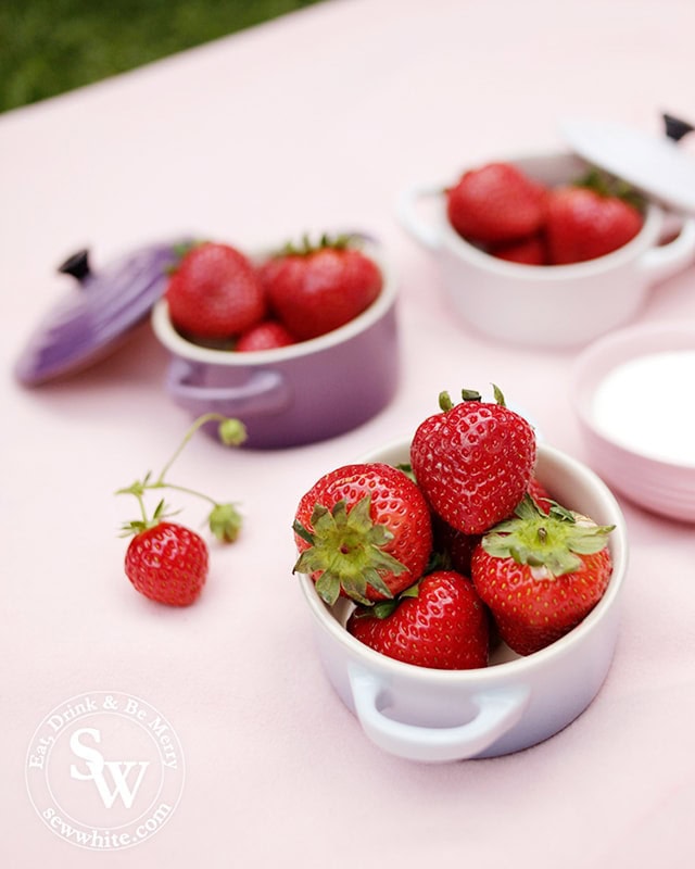 Le Creuset petite casseroles in pastel colours filled with strawberries for a perfect Wimbledon finals party.
