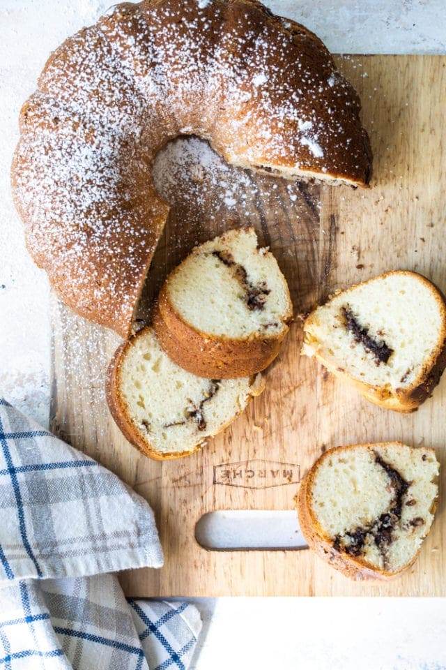 overhead view of Sour Cream Hazelnut Bundt Cake on a wooden cutting board