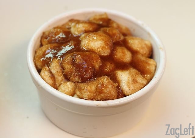 Mixture of melted butter, sugar, and cinnamon topping the apple fritter monkey bread in a ramekin