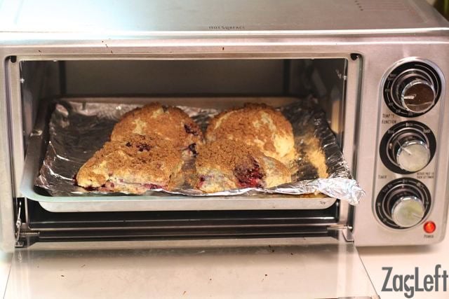 Four scones on a baking sheet in the toaster oven