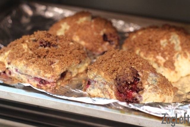 Four scones on a baking sheet in a toaster oven