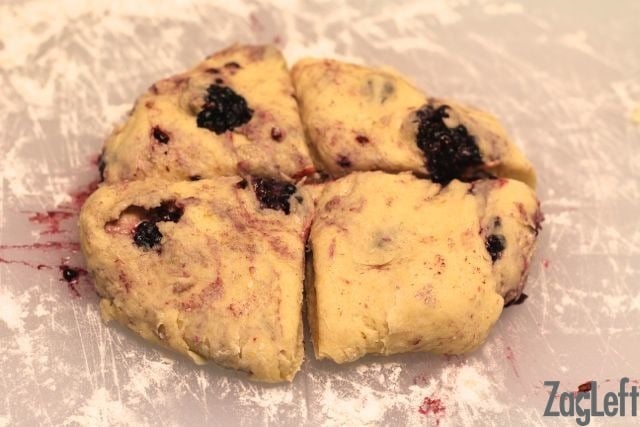 Slicing berry scones into four pieces