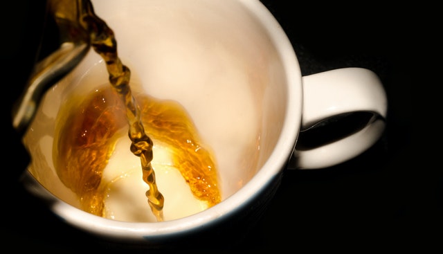 pouring a hot cup of tea pouring a hot cup of tea