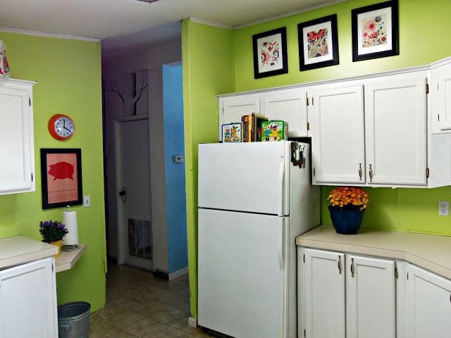 kitchen with green walls and white cabinets