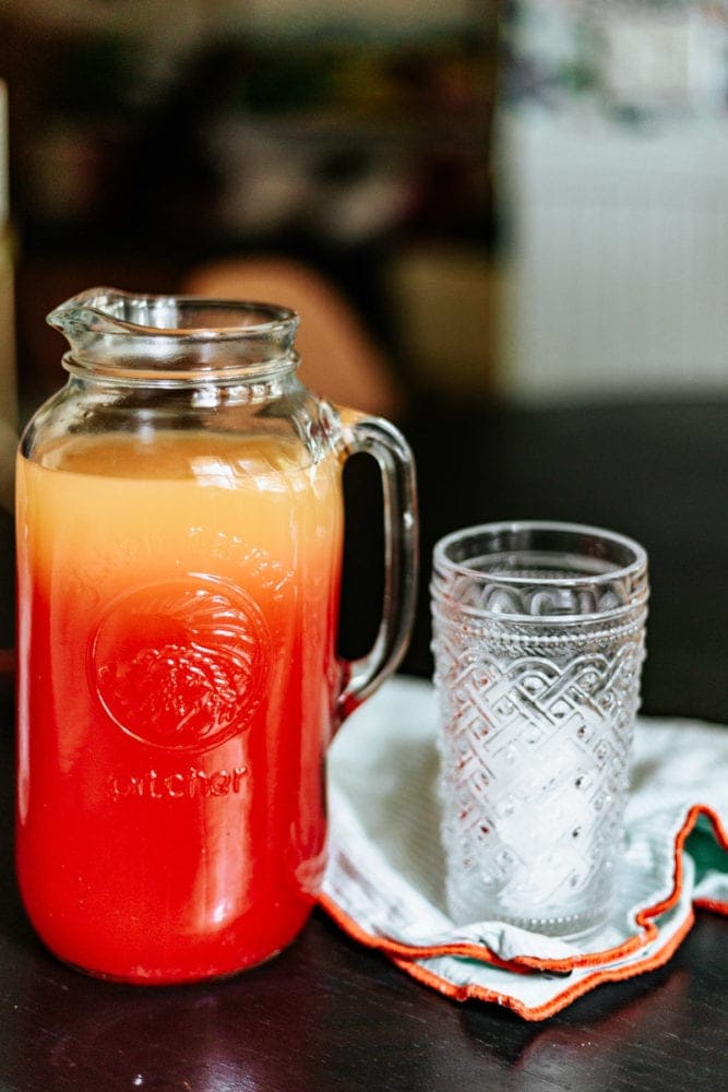 pitcher of a summer cocktail next to an empty glass