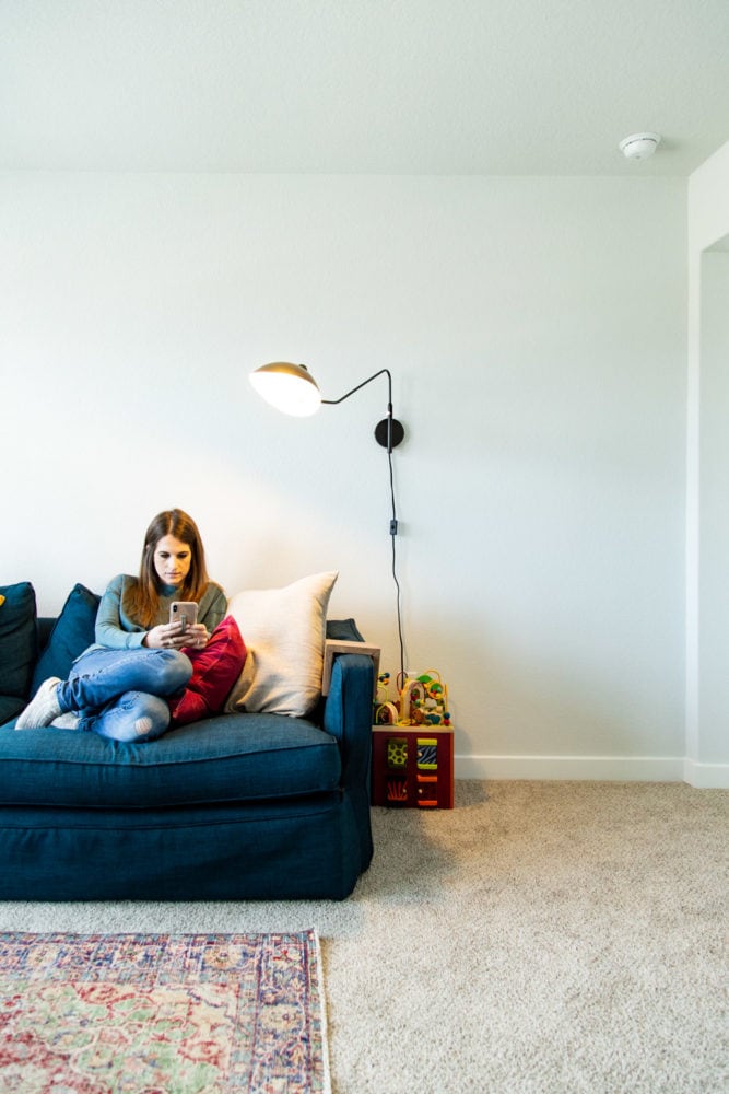 woman on a couch with a lamp overhead