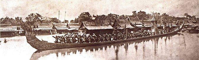 Sepia tone photo from 1865 showing Thai royal barge processional on river