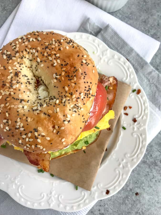 Bacon Egg And Avocado Breakfast Bagel With Peanut Butter On Top