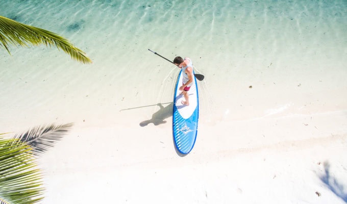 You can even surf on an inflatable SUP Man getting ready to surf on an inflatable stand up paddle board