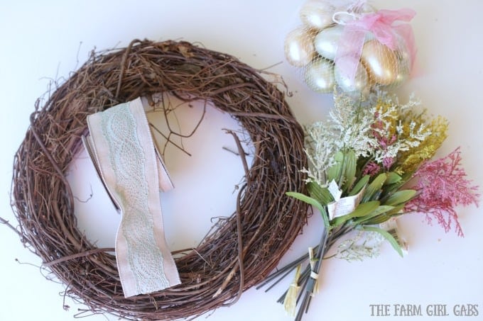 Brighten up your front door with this easy and welcoming DIY Spring Easter Egg Wreath. It's the perfect way to welcome spring. #SpringWreath #Easter #Wreath