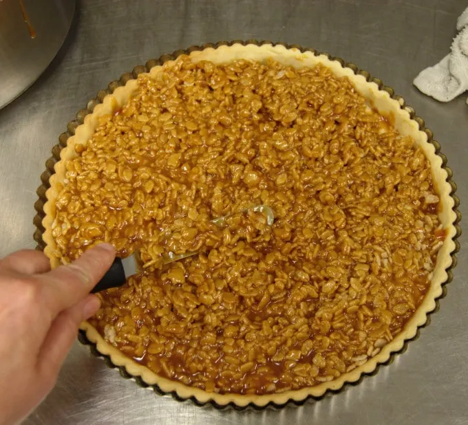 Drizzle the hot caramel over the Rice Krispies, then use a small spatula to mix the cereal into the caramel. Leave no dry cereal.