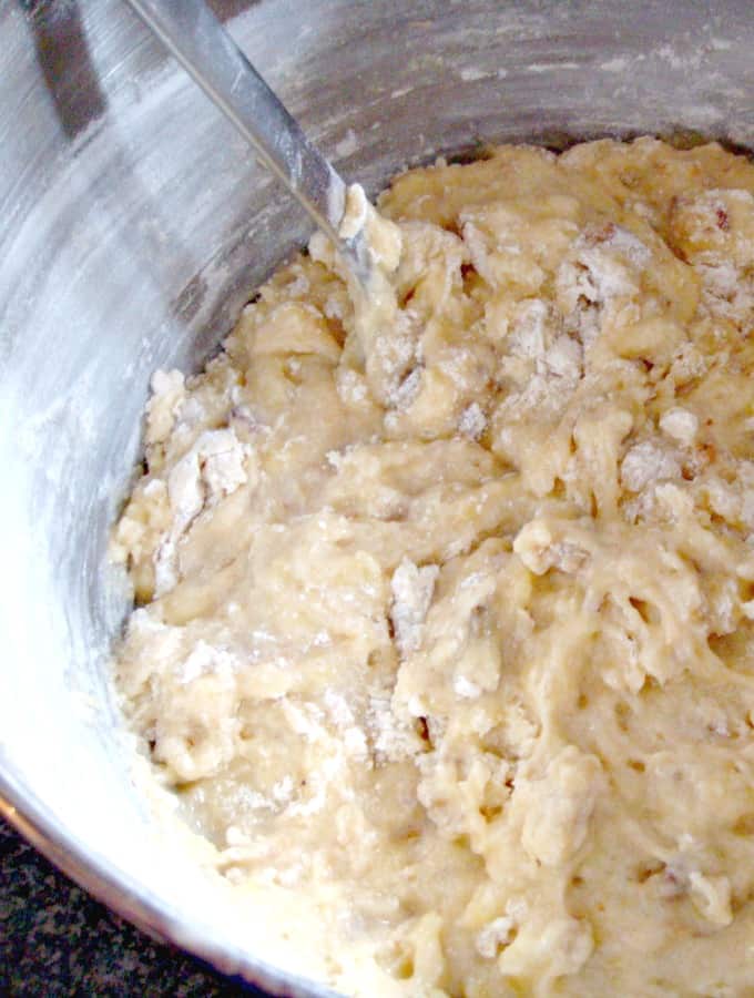 The BEST Banana Walnut Loaf Pouund cake, showing folding in flour to banana cake batter