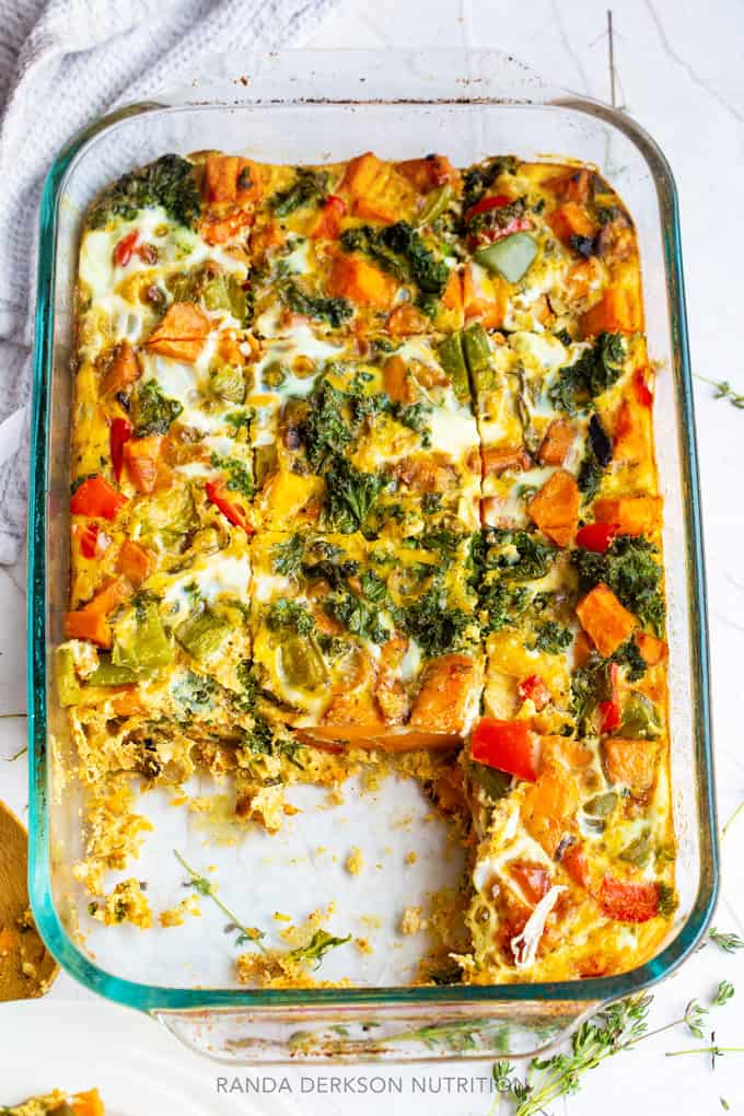 two sliced of a healthy egg casserole recipe missing from a 9x13 glass pan
