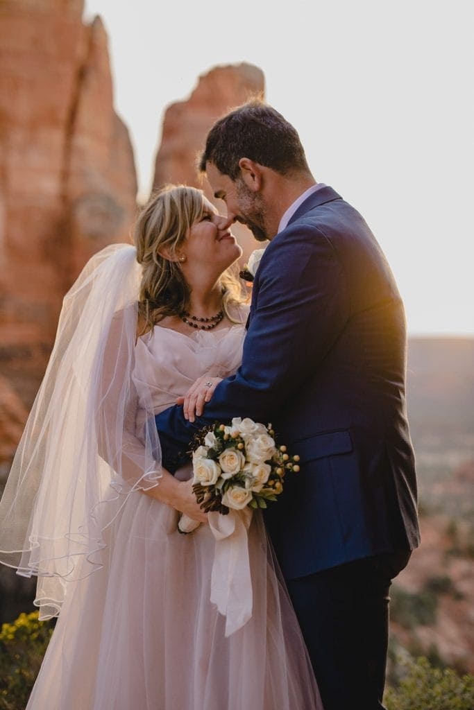 Bride and groom gaze into each others eyes after their Sedona elopement at sunset