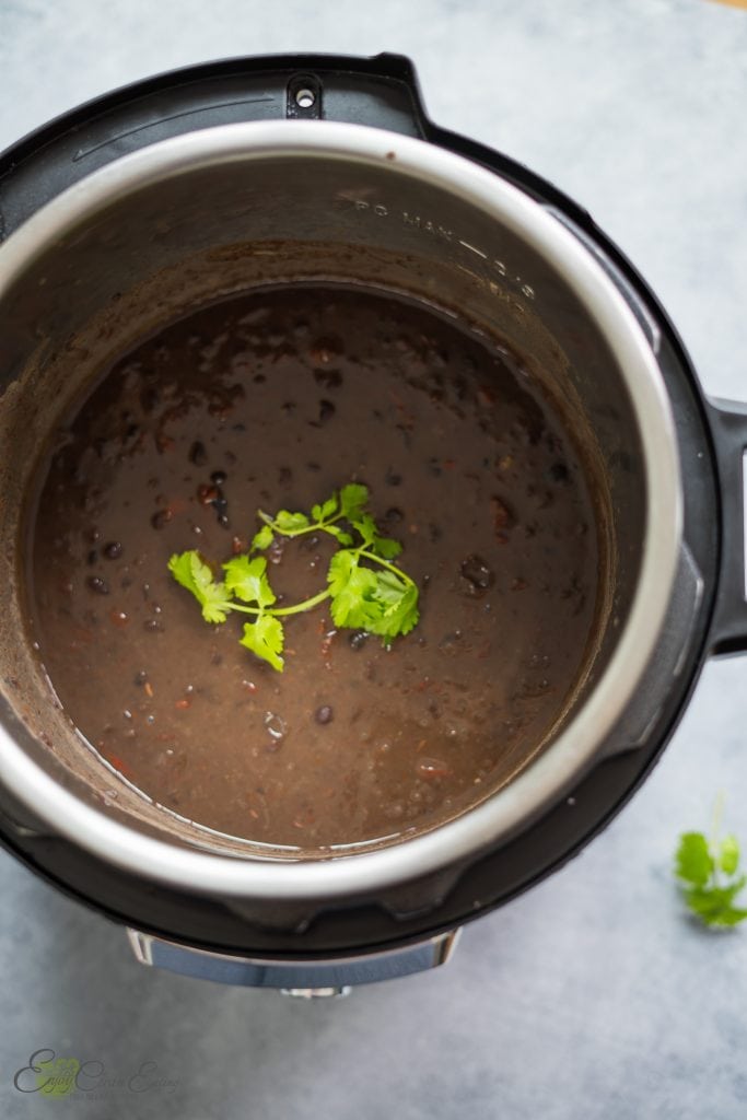 The final results of the pressure cooked cuban black beans, creamy and delicious with Sprinkle of cilantro.