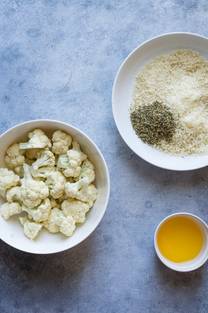 ingredients in different bowls to make cauliflower in the air fryer.