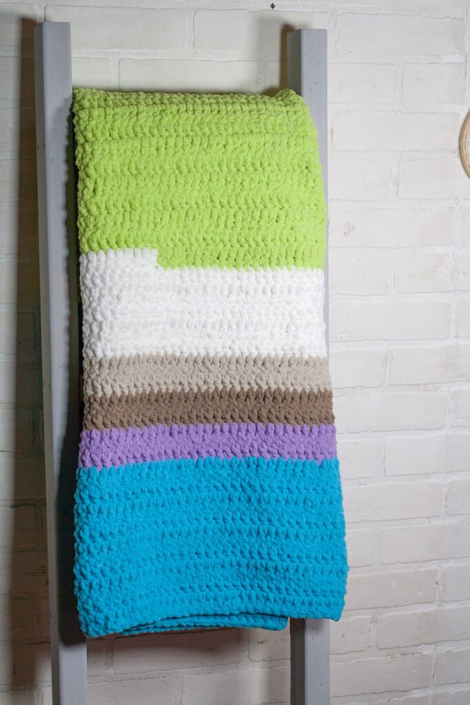 This free crochet pattern is perfect for beginners. You will want to snuggle up all winter in this beginner crochet blanket.