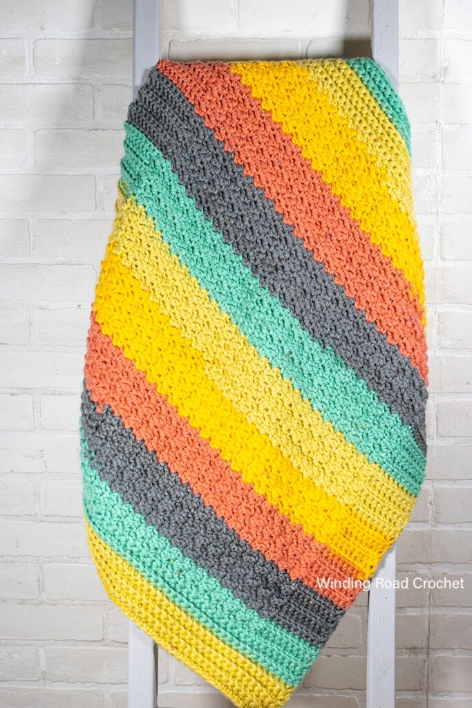 You will love this easy crochet baby blanket pattern. It works up quickly and is beginner friendly. Free crochet pattern with video tutorial.