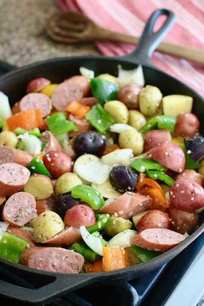 peppers and sausage in cast iron skillet
