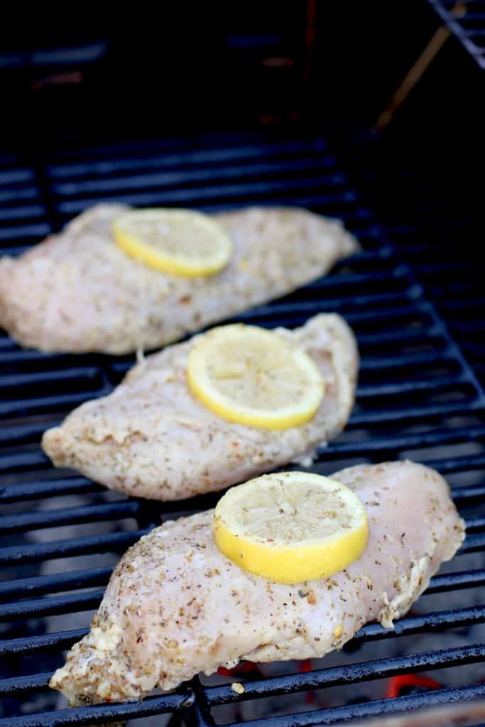 marinated chicken on grill with lemon