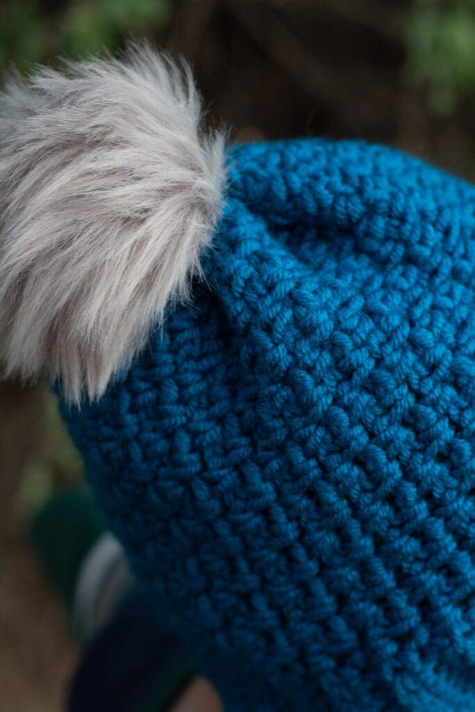 Crochet this quick and easy beanie with a free crochet pattern by Winding Road Crochet. It just takes one skein of yarn to make this 2 hour crochet beanie. #crochethat #crochetbeanie