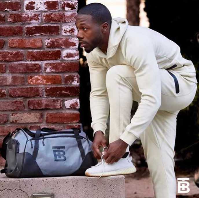 running gear, a man in running equipment with a gym bag, preparing for a workout
