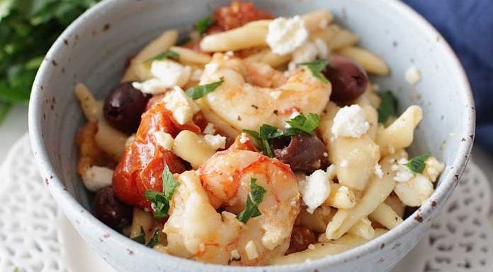 Quick and easy Mediterranean Shrimp and Pasta For One, a hearty and flavorful single serving meal filled with juicy shrimp, oven roasted tomatoes, salty Kalamata olives and creamy Feta cheese. The perfect amount if you're cooking for one. | One Dish Kitchen
