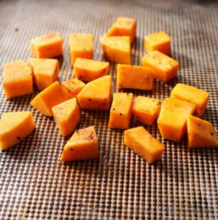 roasted butternut squash on a baking sheet before roasting in the oven | one dish kitchen