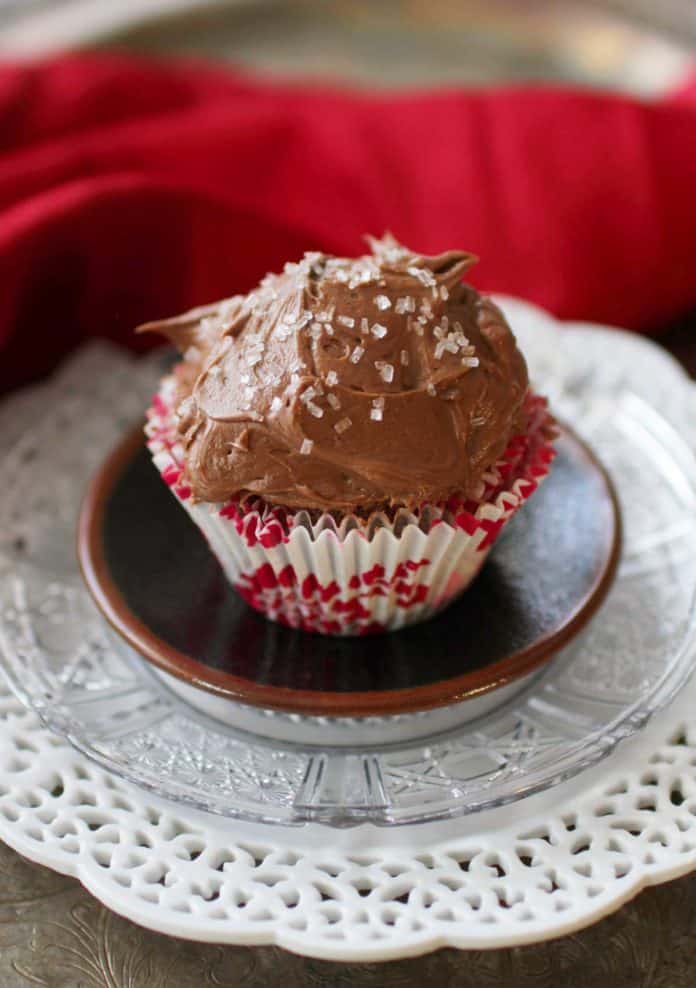 One chocolate cupcake with chocolate frosting and sprinkles on a plate | one dish kitchen