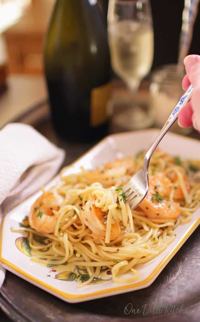 eating shrimp scampi with a fork surrounded by the scampi sauce | one dish kitchen