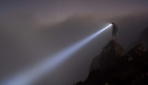 Some rechargeable headlamps have zoom lenses you can use to focus the light beam. These are especially nice in low visibility weather. high lumen rechargeable headlamp shining into fog
