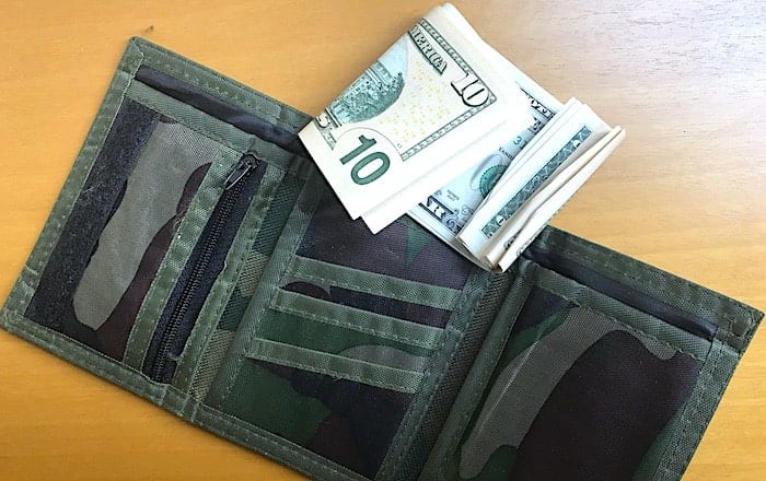 三つ折り財布と折れたドル紙幣の画像
