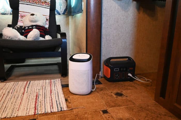 RV dehumidifiers can be powered by small solar power stations like the Jackery 500. Small RV dehumidifier being powered by a solar power station in a camper
