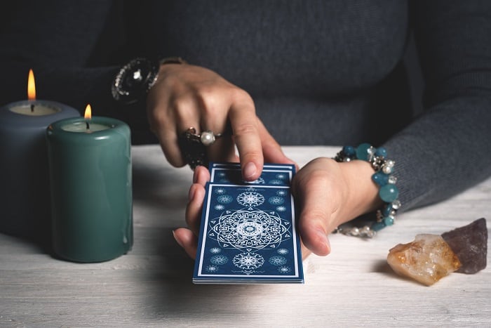 tarot numerology reversed person pulling tarot cards