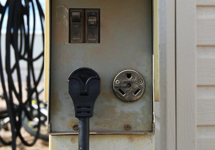 Some RV Parks offer 30 amp power only. In these cases being able to plug a 50A RV surge protector into a 30A outlet is necessary. 30 amp RV power pedestal with an RV surge protector plugged in