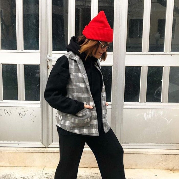 Vianei wears her red hat pulled up into a point | 40plusstyle.com