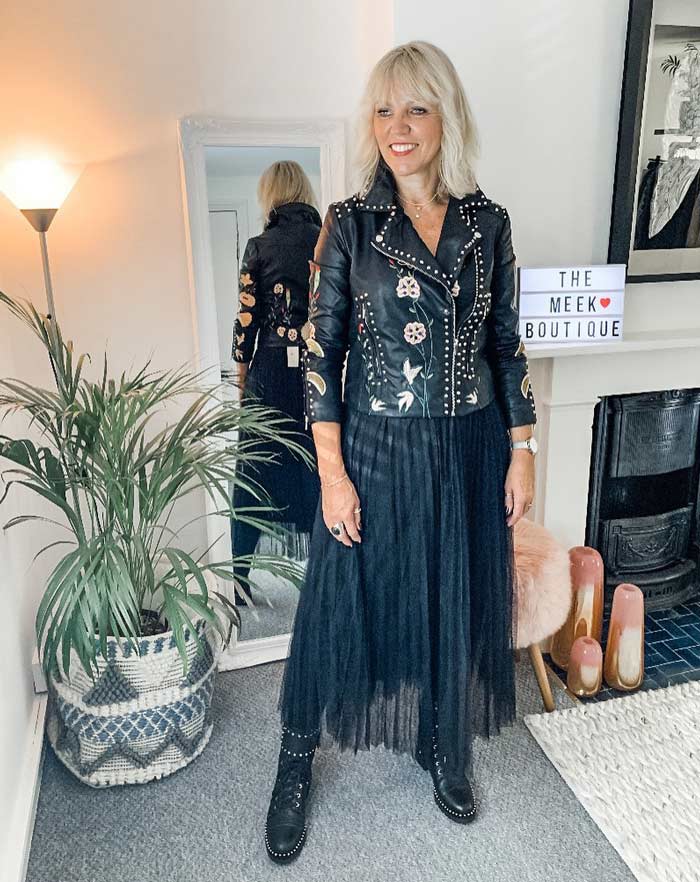 Lynne wearing a rock style moto jacket and black skirt | 40plusstyle.com
