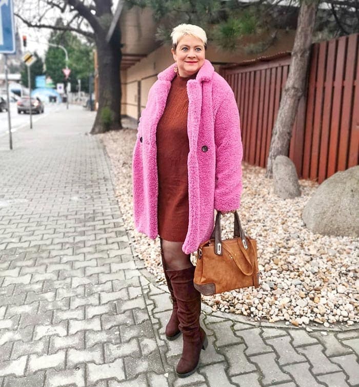 Lucie wears a red sweater dress and pink faux fur coat | 40plusstyle.com