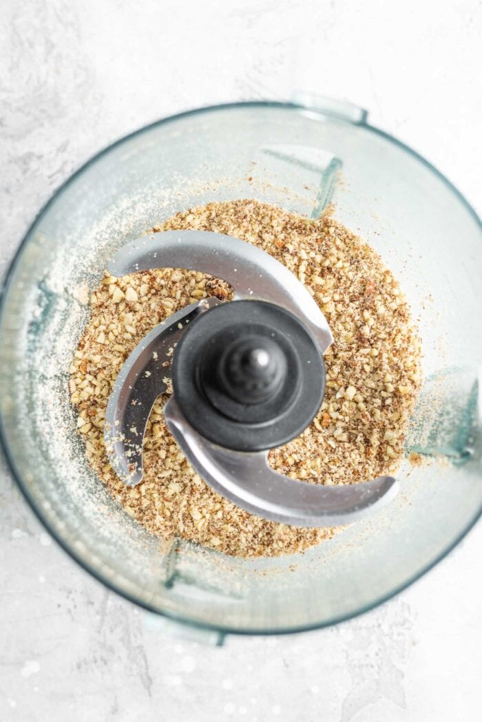 Blended oats and almonds in a food processor.