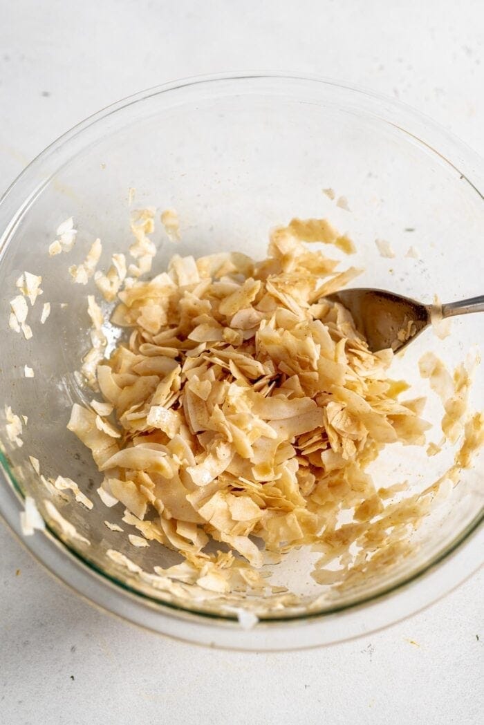 Raw coconut bacon in a glass bowl.