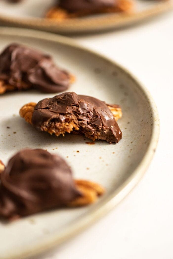 Homemade chocolate vegan turtles on a plate.