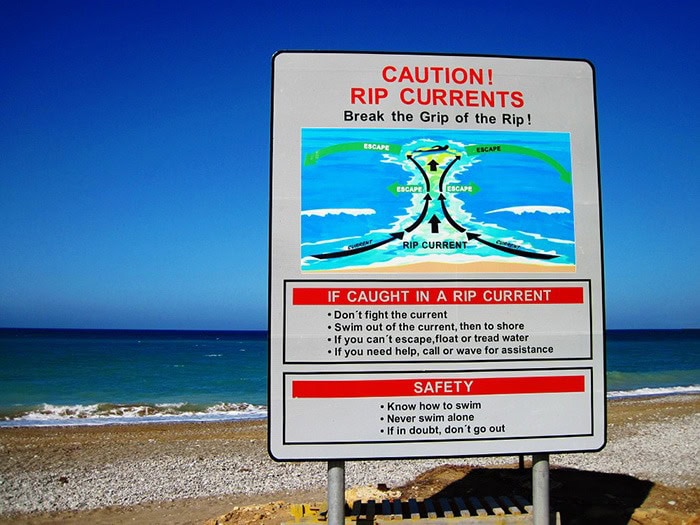 rip currents caution showing the things to do when caught in a rip current and other safety tips at the beach