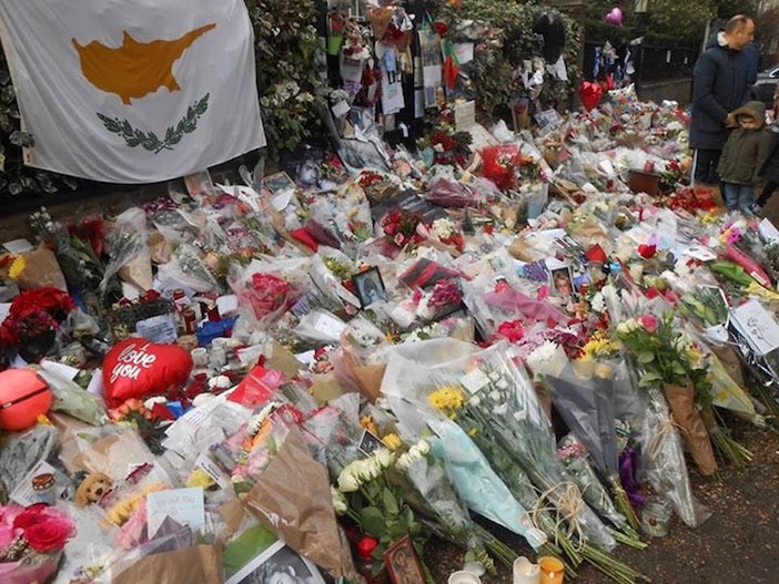 The flag of Cyprus is on prominent display at the make-shift memorial outside Michael's home.