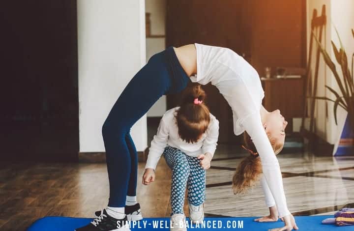 Mom and daughter doing yoga together family fitness