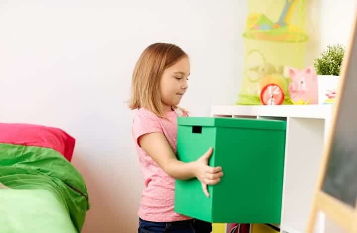 A child decluttering and organizing their toys